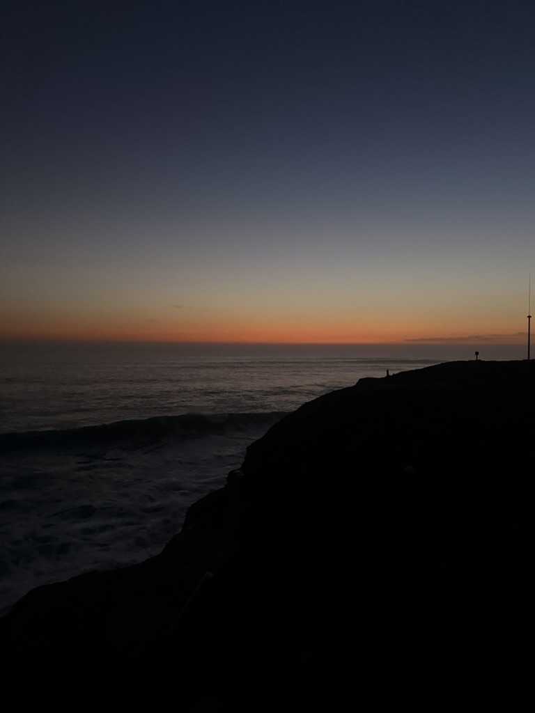 Cliff silhouette at sunset over the Pacific Ocean